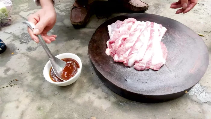 Nướng thịt: Đặt thịt ba chỉ lên vỉ nướng, nướng chín vàng đều các mặt. (Quét thêm mật ong hoặc gia vị lên bề mặt thịt trong quá trình nướng để tạo màu sắc đẹp mắt và tăng thêm hương vị)