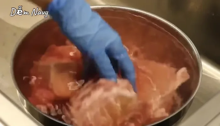 Rửa lại xương bò sau khi ngâm.