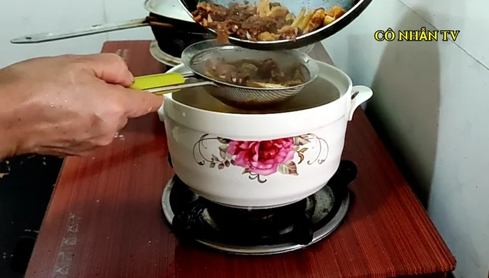 Lọc nước lẩu để loại bỏ cặn.