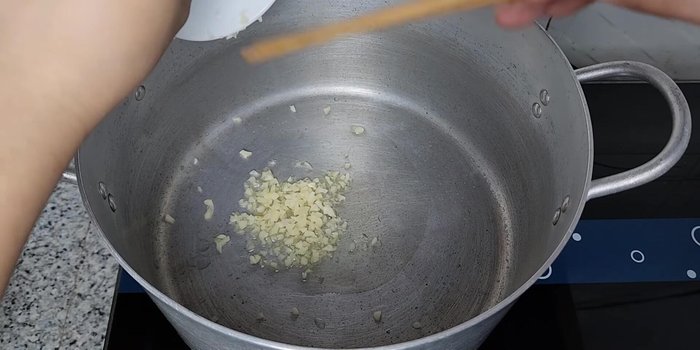 Cho dầu ăn vào nồi, phi thơm tỏi băm, tiếp theo cho sả, gừng và ớt vào phi chung cho thơm.
