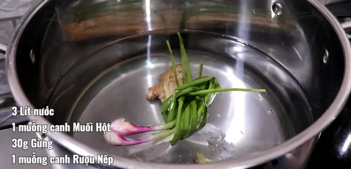 Trụng xương bò: Cho 3 lít nước, 1 muỗng canh muối hột, 30g gừng đập dập, 3 nhánh hành, 1 muỗng canh rượu vào nồi. Cho xương ống, thịt bò, khăn lông vào, ngâm ít nhất 1 tiếng để khử mùi. Sau khi nước sôi, vớt ra, rửa sạch.