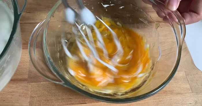 Đánh lòng đỏ trứng và chuối: Trộn đều lòng đỏ, chuối và dầu ăn.