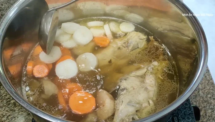 Thêm củ cải trắng, cà rốt (cắt khúc 1cm) và bò viên vào. Đun sôi, hạ lửa nhỏ.