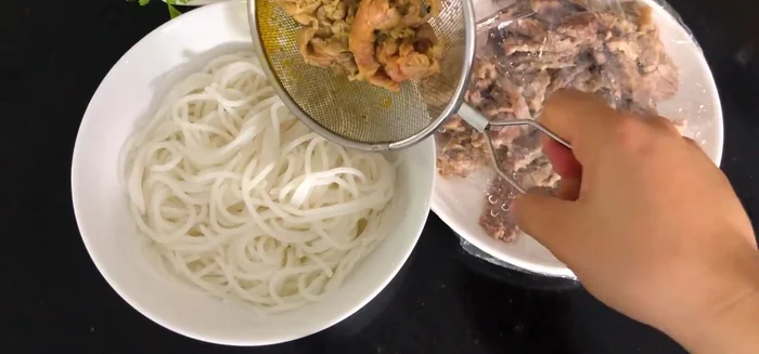 Cho bún vào tô, chan nước dùng, xếp thịt bò lên trên.