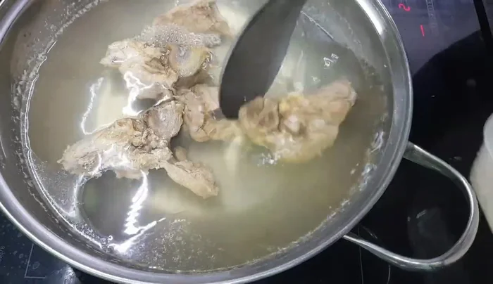 Cho gạo vào nồi, thêm nước hầm xương (đã hầm khoảng 2 tiếng). (13.59)