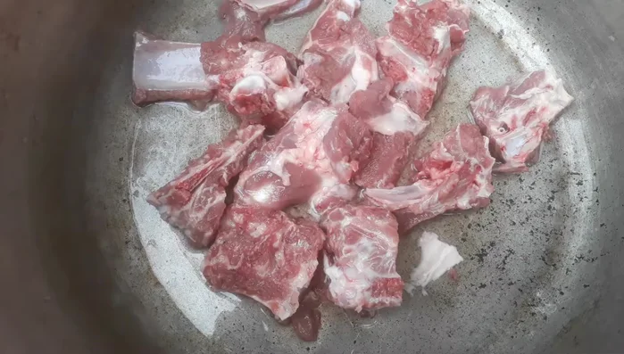 Chặt xương heo thành từng khúc, chần sơ qua nước sôi rồi vớt ra.