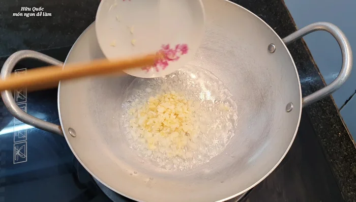 Phi thơm hành tỏi: Phi thơm hành lá (phần gần gốc) và tỏi trong chảo với dầu ăn (377.759).