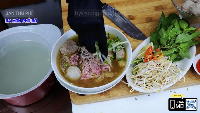 Thêm hành ngò và gia vị: Cho hành ngò, tiêu lên trên tô phở.