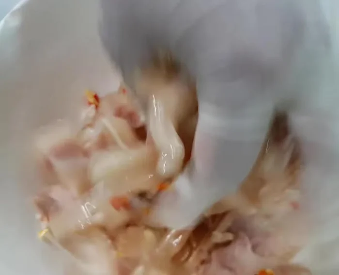 Trộn gỏi: Cho xoài, cà rốt, hành tây, tai heo vào tô lớn. Thêm 3 muỗng canh nước chấm đã pha vào trộn đều.