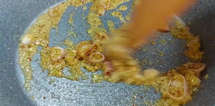 Cho chuối vào chảo, thêm tương ớt để tạo màu đẹp. Đảo đều khoảng 1 phút.
