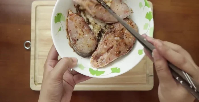 Ướp cá trong tô khoảng 30 phút cho cá thấm gia vị.
