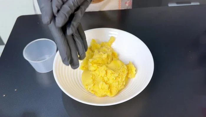 Nặn nhân đậu xanh thành từng viên nhỏ (khoảng 80g/viên) để chuẩn bị cho vào khuôn bánh.