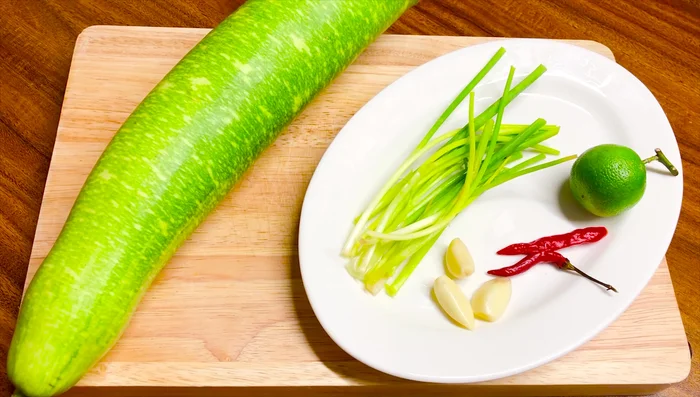 Cắt hành lá cho vào nước luộc bầu làm canh.