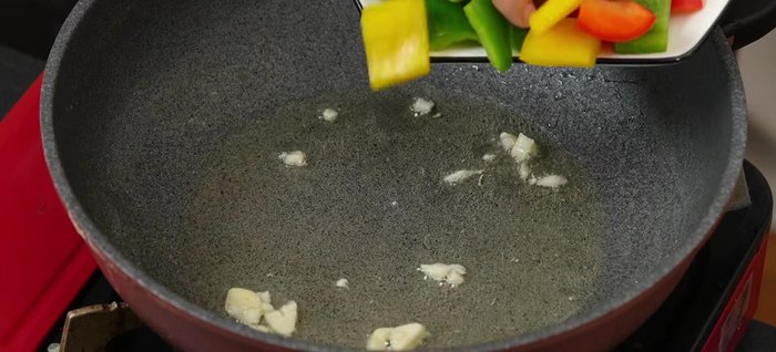Phi thơm ½ chỗ tỏi băm, xào ớt chuông và hành tây nhanh tay với lửa lớn (1-2 phút), để rau giữ độ giòn.
