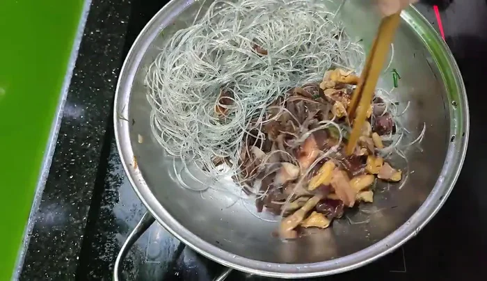 Thêm lòng mề đã xào, mộc nhĩ, nấm hương vào xào cùng.