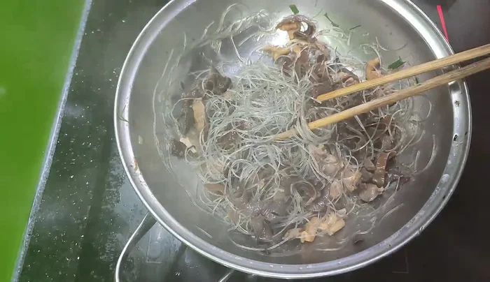 Cho nước luộc gà vào, nêm nếm gia vị (nước mắm, muối, hạt nêm, bột ngọt).