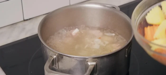 Cho khoai tây và cà rốt vào, đun sôi lại. Nêm gia vị (bột canh, bột nêm, bột ngọt, nước mắm) cho vừa ăn. (211.58)