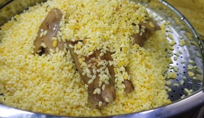 Thêm mỡ hành vào xôi khi sắp hoàn thành.