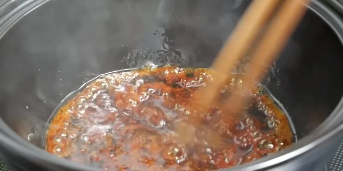 Khi đường tan chảy và có màu đẹp, cho hành tím, tỏi, ớt vào xào thơm.